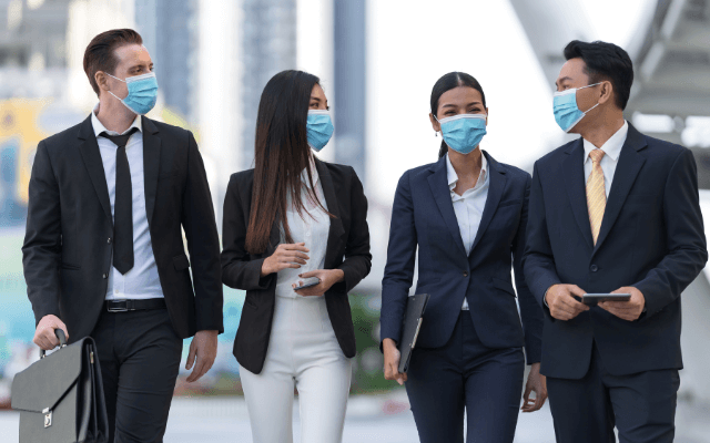 Four corporate employees in face masks