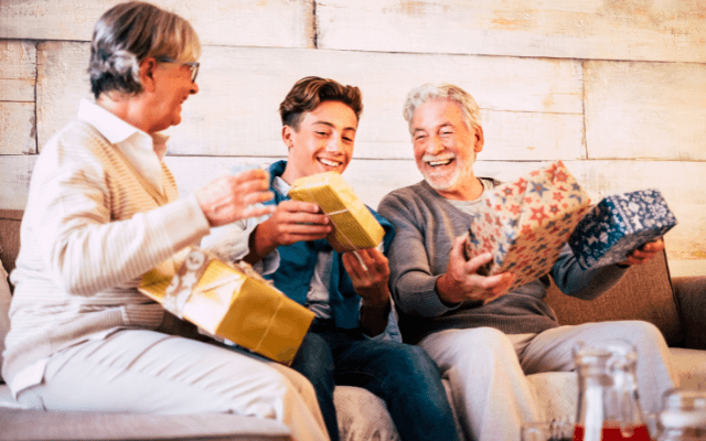 Grandson exchanging gifts with grandparents