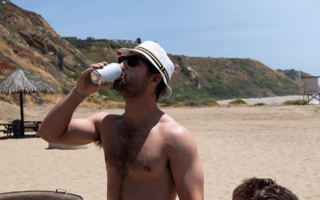 Young man at the beach in a bucket hat